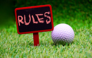 Rules of Golf Sign on Green Grass