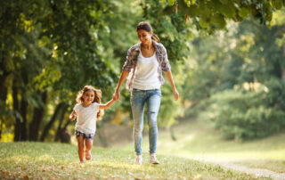 Mother and Daughter Playing and Running Around the Park on Beautiful Morning