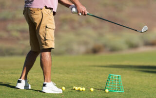 Golf Player Making a Swing With a Golf Fairway Wood Course on the Golf Practice