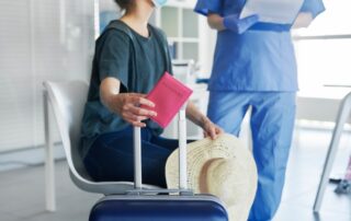 Close,Up,Woman,Holding,Passport,And,Luggage,During,Medical,Test